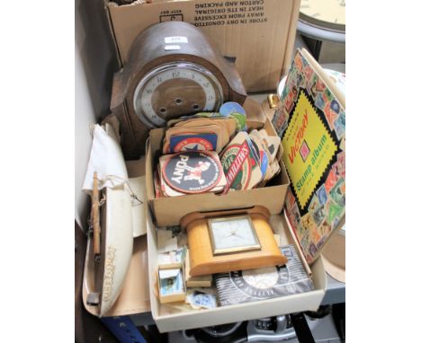 A tray containing wooden pond yacht, oak cased mantel clock, Victory stamp album, loose stamps, beer mats etc