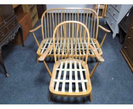 An Ercol elm two seater settee and armchair, lacking cushions CONDITION REPORT: Cosmetically in poor condition. Both pieces n