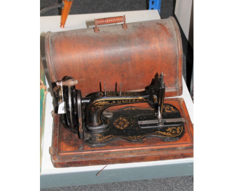 A vintage Singer hand sewing machine in case
