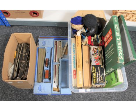 A box containing Hornby track and part train set together with a crate of board games, Subbuteo set, vintage doll etc