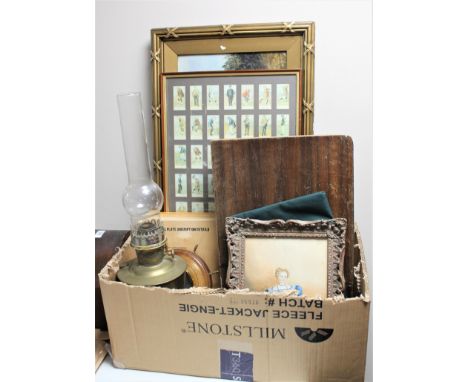 A box containing cutlery canteen, onyx chess pieces, Aladdin brass oil lamp with chimney, framed golfing cigarette cards, bar