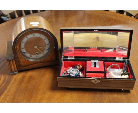 A jewellery box of costume jewellery together with an oak cased mantel clock