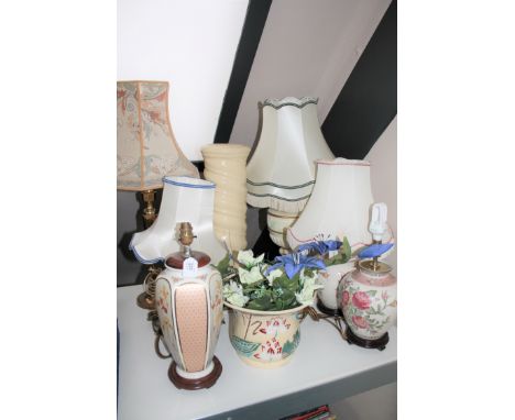 A pottery jardiniere on stand together with a brass table lamp and shade and five other table lamps