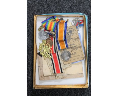A box containing military items including two WWI medals presented to 36506 PTE. E. BURTON. LEIC. R. together with his Nation