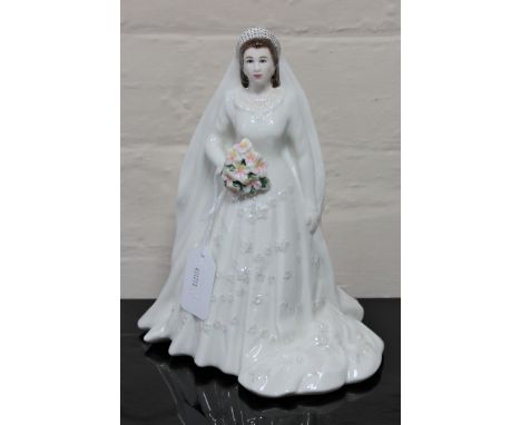 A Royal Worcester china figurine : Her Majesty Queen Elizabeth II (Diamond Jubilee Edition), height 23 cm. 