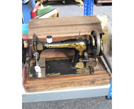 An oak cased vintage Singer hand sewing machine