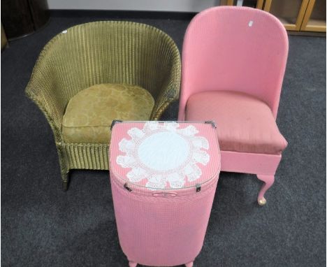 A three piece pink loom bedroom set comprising blanket box, bedroom chair and linen box, together with a gold Lloyd Loom bask