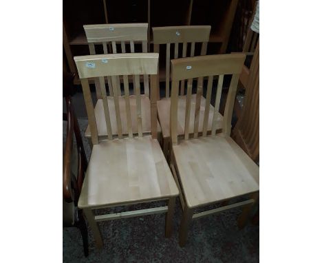 A set of four light wood chairs.  