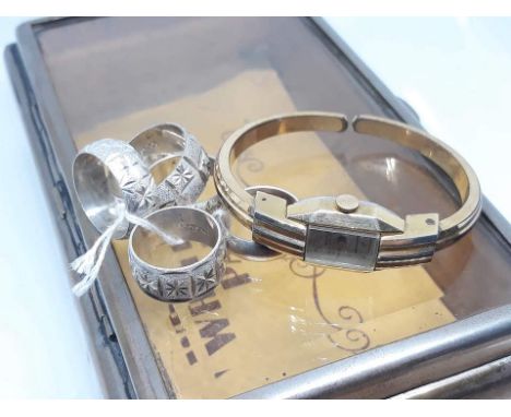 A box containing five rings marked 'Sterling Silver' and a Remiz gold plated bangle watch.  