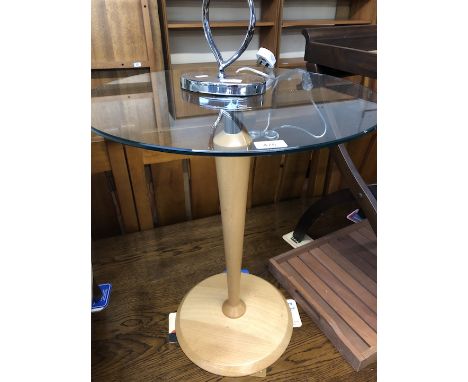 A modern round glass top and light wood pedestal table, height 66cm.  