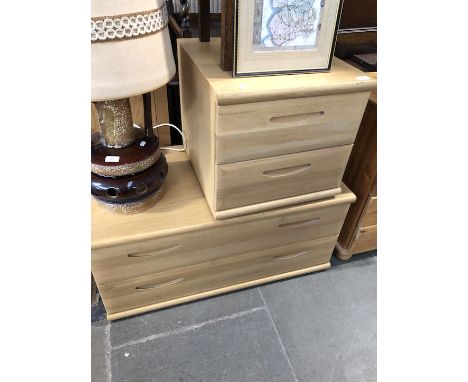 Two light wood chests of drawers.  
