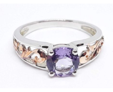 A silver solitaire ring set with an amethyst coloured stone, marked '925', size V, with box.  