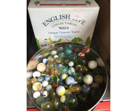 A Wade teapot and a tub of vintage marbles  