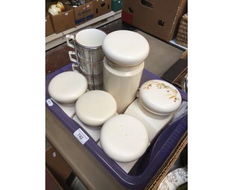Crate of kitchen jars and cups  