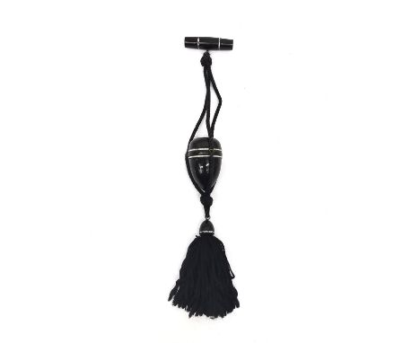 An Art Deco plastic, possibly Bakelite acorn shape powder compact and lipstick on silk chord with and tassel, paste set bands