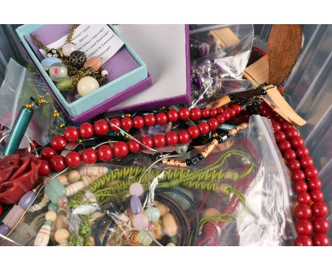A lady's collection of vintage fashion jewellery, including plastic rings, beads with moulded flower heads, jade and plaited 