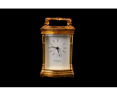 A David Peterson serpentine carriage clock, with bevelled glass and heavy brass case, 12cm high 
