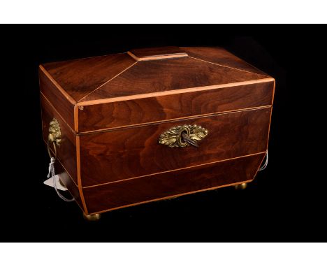 A 19th century tea caddy, of sarcophagus shape in mahogany with boxwood stringing,  brass lion mask handles and key escutcheo