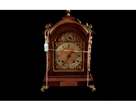 A large oak bracket clock, 8 day movement striking on two gongs, with silvered chapter ring and roman numerals ,matted dial w