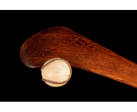 A hurling stick and ball, by O'Neills, sports goods, "Choice of Champions".