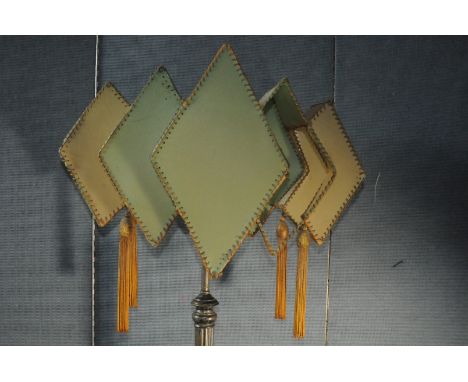 An Art Deco standard lamp, the plated column support having abstract green shadethe shade is torn in places, with the frame b