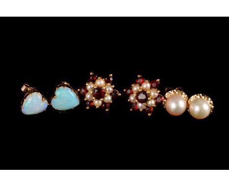 A pair of garnet and seed pearl daisy cluster earrings, a pair of solitaire pearl earrings, and a pair of heart shaped white 