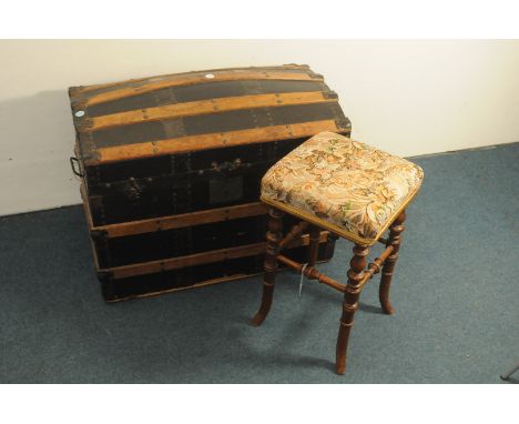 A vintage travel trunk and piano stool, the trunk with black painted and wooden exterior and havig lift out tray, the stool o