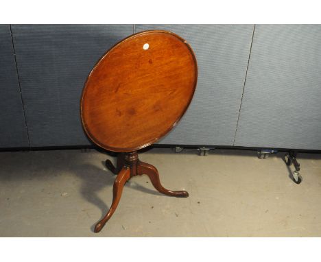 A Georgian period mahogany ocassional table, with circular snap top on tripod pedastal on pad feet