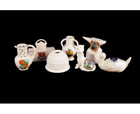 An assortment of crested china, including Carbis Bay anvil and ship, Weston Super Mare stove, Boscome cat, Seaton hip flask a