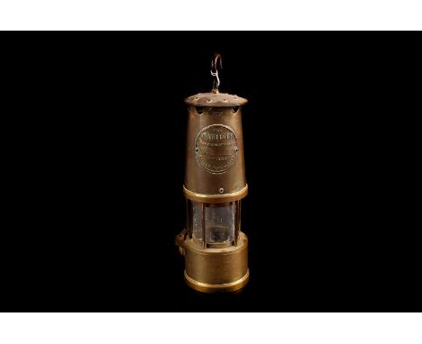 A Miners lamp, brass construction ,"The Protector",  Light and Lighting Co Ltd makers, Eccles Manchester, with iron hanging h