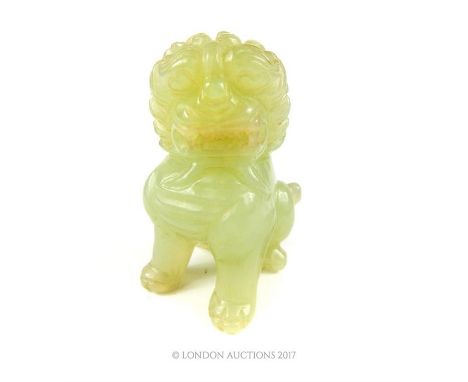 A Chinese carved jade Dog of Fo, seated on its back legs, 6 x 4 x 5cm.