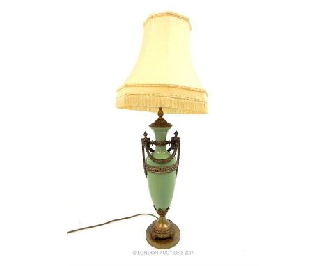 A celadon green ceramic table lamp with classical style cast metal mounts and shade, 81 x 30 x 30cm.