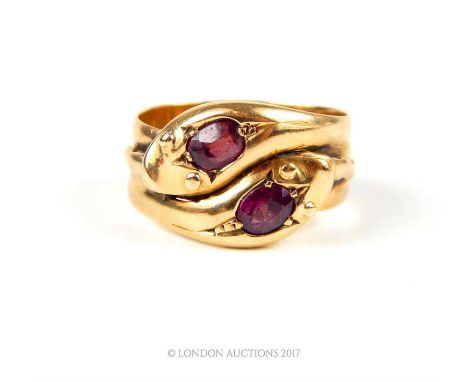 An antique, 18 ct yellow gold and ruby snake ring, the design composed of two coiling snakes, each snake head inset with an o