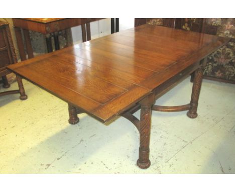 DRAWLEAF DINING TABLE, early 20th century oak on turned spiral column supports joined by a wavy stretcher, 183.5cm L extended