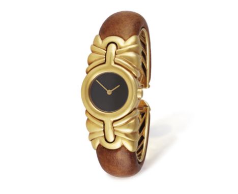 BULGARI: AN 18K GOLD 'ANTALYA' BANGLE WATCHThe 6-jewel Cal-512 quartz movement, black dial with gilt hands, polished bezel wi