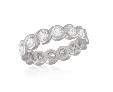 A DIAMOND ETERNITY RINGComposed of a continuous row of brilliant-cut diamonds, mounted in 18K gold, diamonds approximately 1.