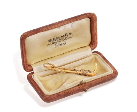 HERMÈS: A GOLD BROOCH, CIRCA 1960Designed as a riding crop, with ropetwist detailing, in 18K gold, signed Hermès Paris, Frenc