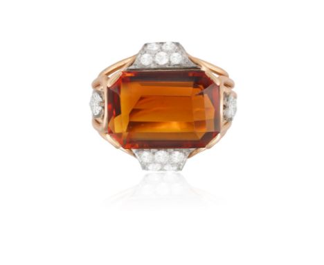 A CITRINE AND DIAMOND DRESS RING, CIRCA 1950Set horizontally, the cut-cornered rectangular citrine weighing approximately 9.5