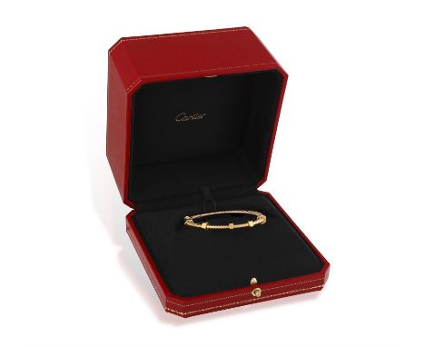 CARTIER: A GOLD 'ÉCROU DE CARTIER' BRACELETThe oval bracelet designed as a circular reeded bolt with four movable nuts and tw
