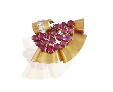 A RETRO RUBY AND DIAMOND CLIP BROOCH, FRENCH, CIRCA 1940Of openwork scroll design, set with a cluster of circular-cut rubies 