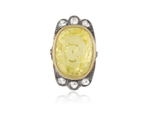 A YELLOW SAPPHIRE AND DIAMOND RINGCollet-set with a cushion-shaped yellow sapphire, within a mount set with rose-cut diamonds