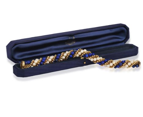 VAN CLEEF & ARPELS: A LAPIS LAZULI, CULTURED PEARL AND GOLD 'TWIST' BRACELET, CIRCA 1965Of twist rope design, with alternatin
