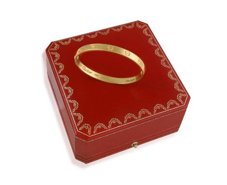 ALDO CIPULLO FOR CARTIER: AN 18K GOLD 'LOVE' BANGLE BRACELET, 1970The hinged bangle decorated with screw motifs, in 18K gold,