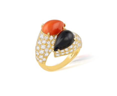 CARTIER: A RARE CORAL AND DIAMOND 'TOI ET MOI ' DRESS RING, CIRCA 1976Of raised crossover design, set with a pear-shaped onyx