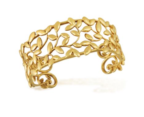 TIFFANY & CO., DESIGNED BY PALOMA PICASSO: A GOLD 'OLIVE LEAF' CUFF BRACELETOf openwork design, embellished with curvilinear 