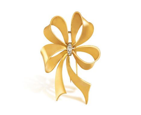 A GOLD AND DIAMOND BROOCH, CIRCA 1950The stylised ribbon bow, centring centring old brilliant and single-cut diamonds, mounte