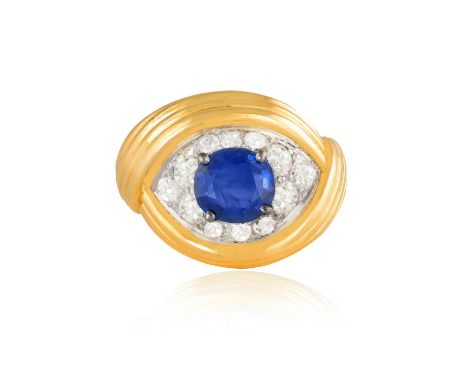 A SAPPHIRE AND DIAMOND DRESS RING, FRENCH, CIRCA 1960The oval-shaped sapphire at the centre, set within an old brilliant-cut 