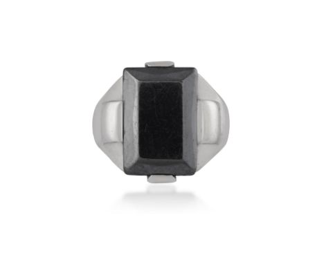 A HEMATITE AND SILVER RING, CIRCA 1940Composed of a rectangular-shaped polished hematite, set between curved panels, to a tap