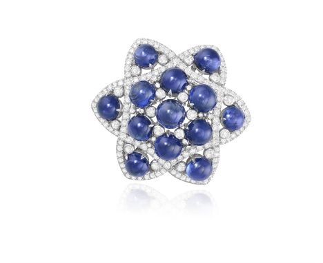 FÜRST: A SAPPHIRE AND DIAMOND BROOCH, CIRCA 1950Of openwork star shape design, set with circular-cut sapphire cabochons, high