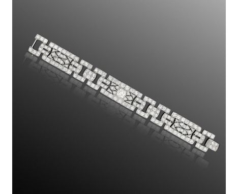  A FINE ART DECO DIAMOND BRACELET, CIRCA 1930Composed of openwork geometric panels with three slightly bombé rectangular plaq